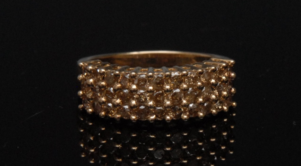 A Cognac diamond pave ring, set with thirty three round brilliant cut diamonds, arranged in three