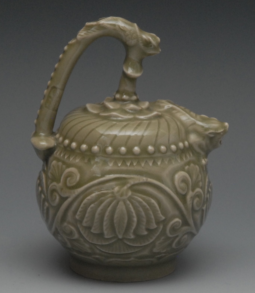 A Chinese celedon globular water dropper, in relief with lotus, mystical beast spout, high handle,