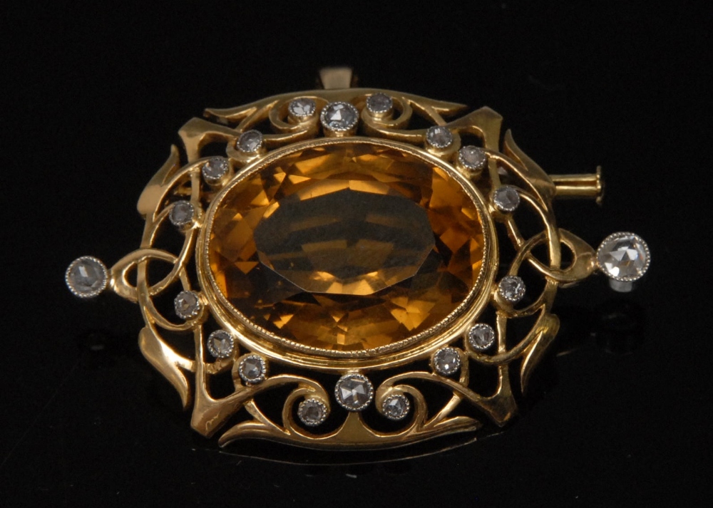 A diamond and citrine pendant brooch, central oval citrine approx 14mm x 18mm,set within Art Nouveau