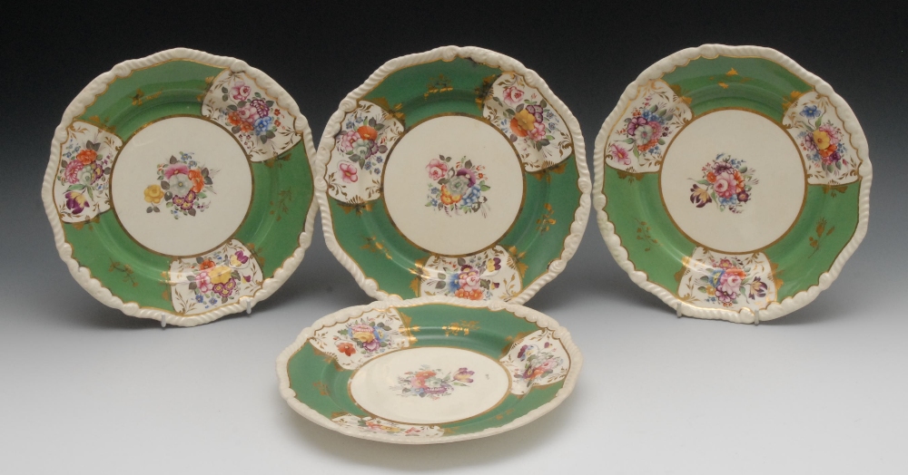 A set of four shaped circular Rockingham plates, the centres painted with bouquet of colourful