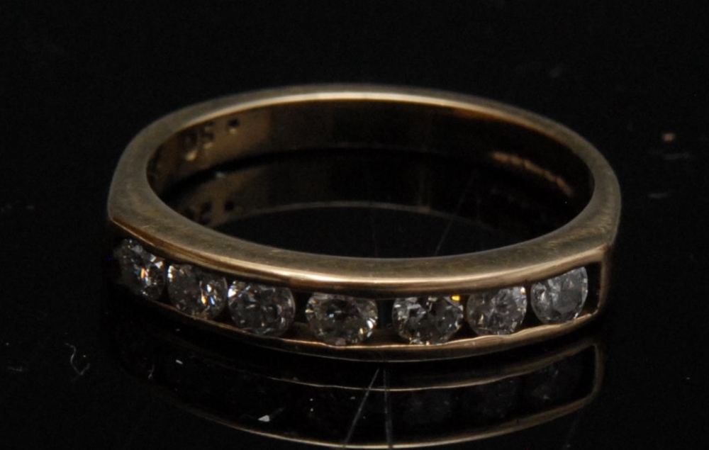 A diamond half eternity ring; seven round brilliant cut diamonds, channel set, total diamond