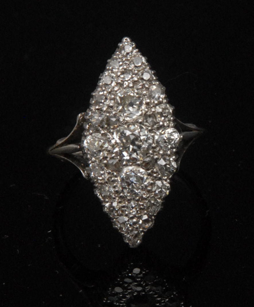 A diamond marquise ring, central old brilliant cut diamond, approx. 0.45ct, flanked by an array of