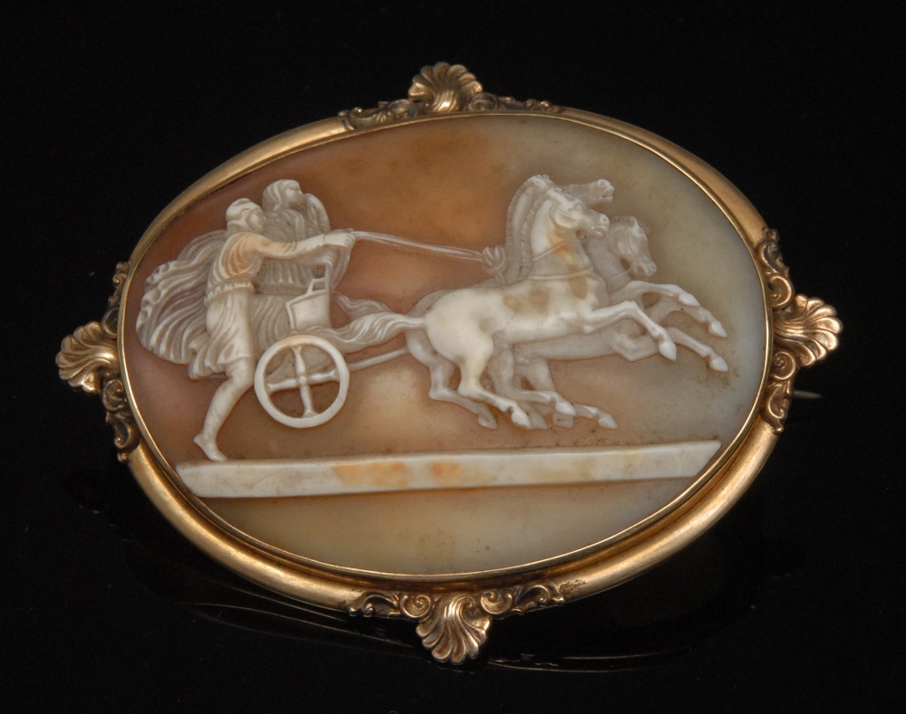 A 19th century oval shell cameo brooch, as a chariot being pulled by three rearing  horses, shell