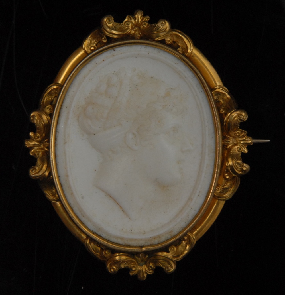 A late 18th/19th century white stone cameo brooch, portrait of a lady facing right, ornate yellow