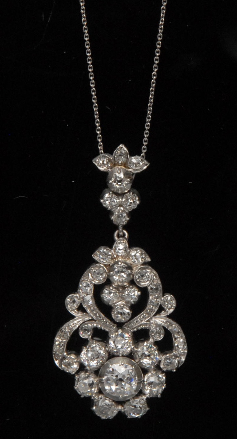 A diamond pendant necklace, open shaped oval floral drop pendant encrusted with thirty eight old