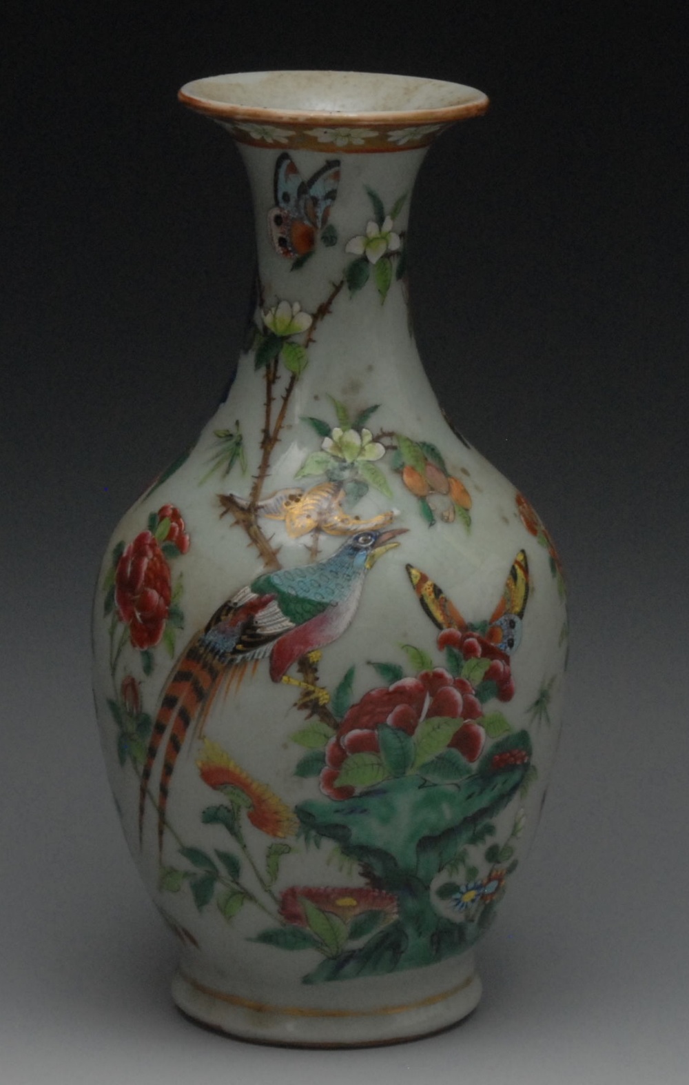 A 19th Chinese bottle vase, decorated in polychrome with a fanciful bird, butterfly and peonies on a