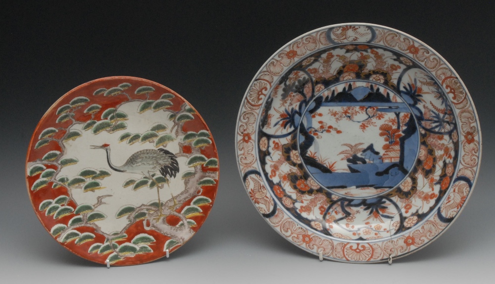 A 19th century Chinese plate, brightly enamelled with a crane perched in a pine tree, coloured in