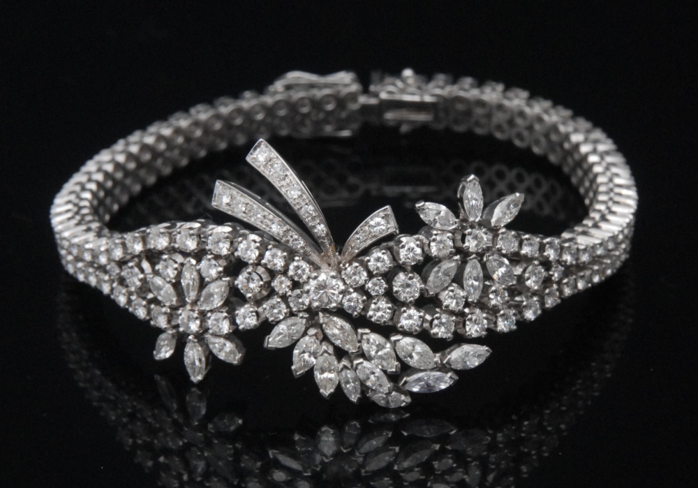 An impressive articulated diamond flower head cluster bracelet,  encrusted with one hundred and