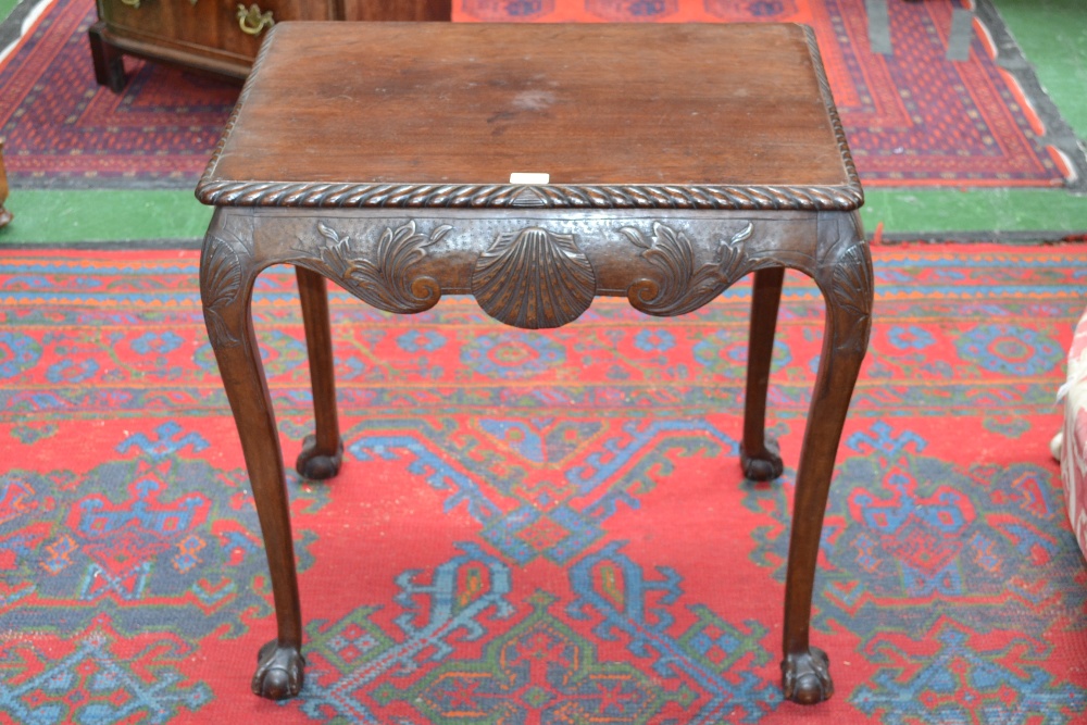An Irish mahogany rectangular tea table, gadrooned top above a deep frieze carved in relief with