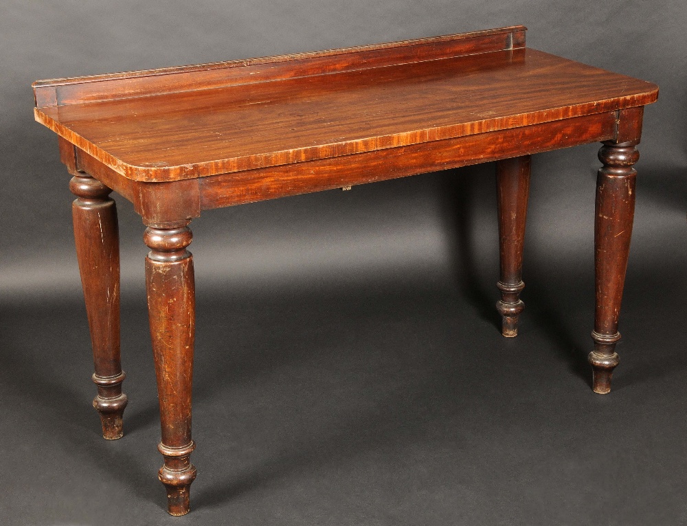 A 19th century mahogany rounded rectangular serving table, turned legs, 91cm high, 152cm wide