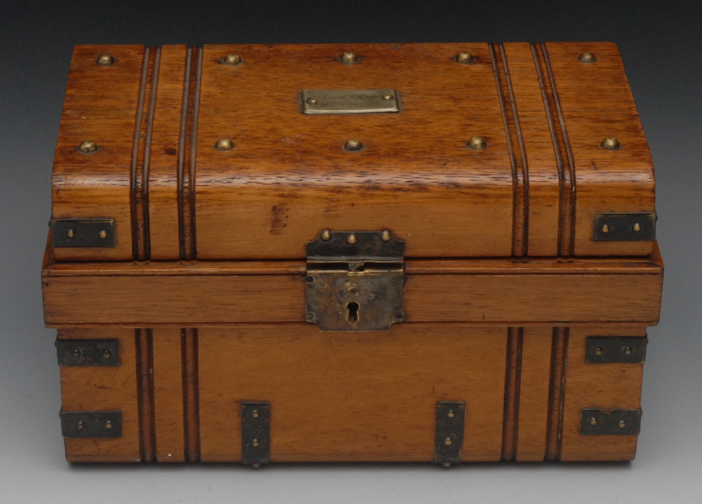 A Victorian oak novelty humidor, as a cabin trunk, hinged cover enclosing a lift out tray with cigar