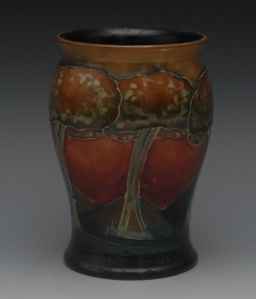 A Moorcroft Eventide pattern slightly baluster vase, tube lined with trees and landscapes in ochre