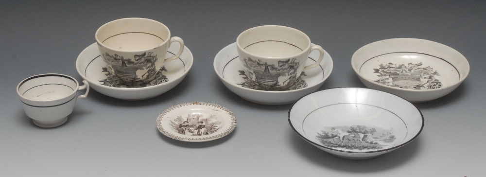 A pair of Staffordshire teacup and saucers, printed in monochrome with memorial inscribed To The