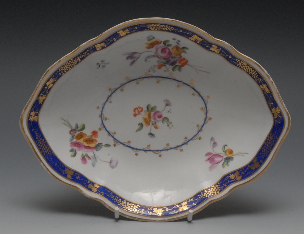 A Chelsea Derby lozenge shaped dish, painted with floral spray within a blue cartouche entwined in