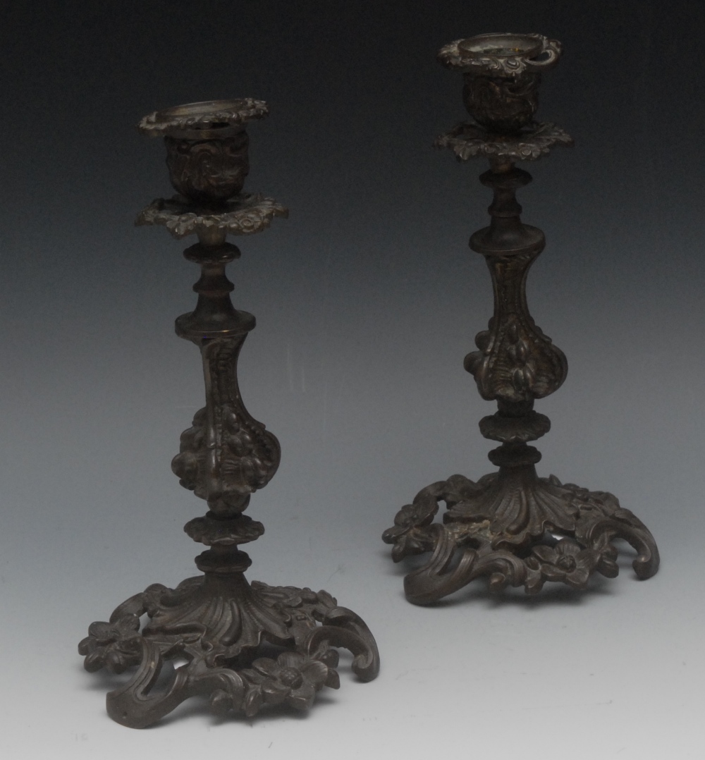 A pair 19th century Rococo Revival dark patinated bronze table candlesticks,detachable nozzles,