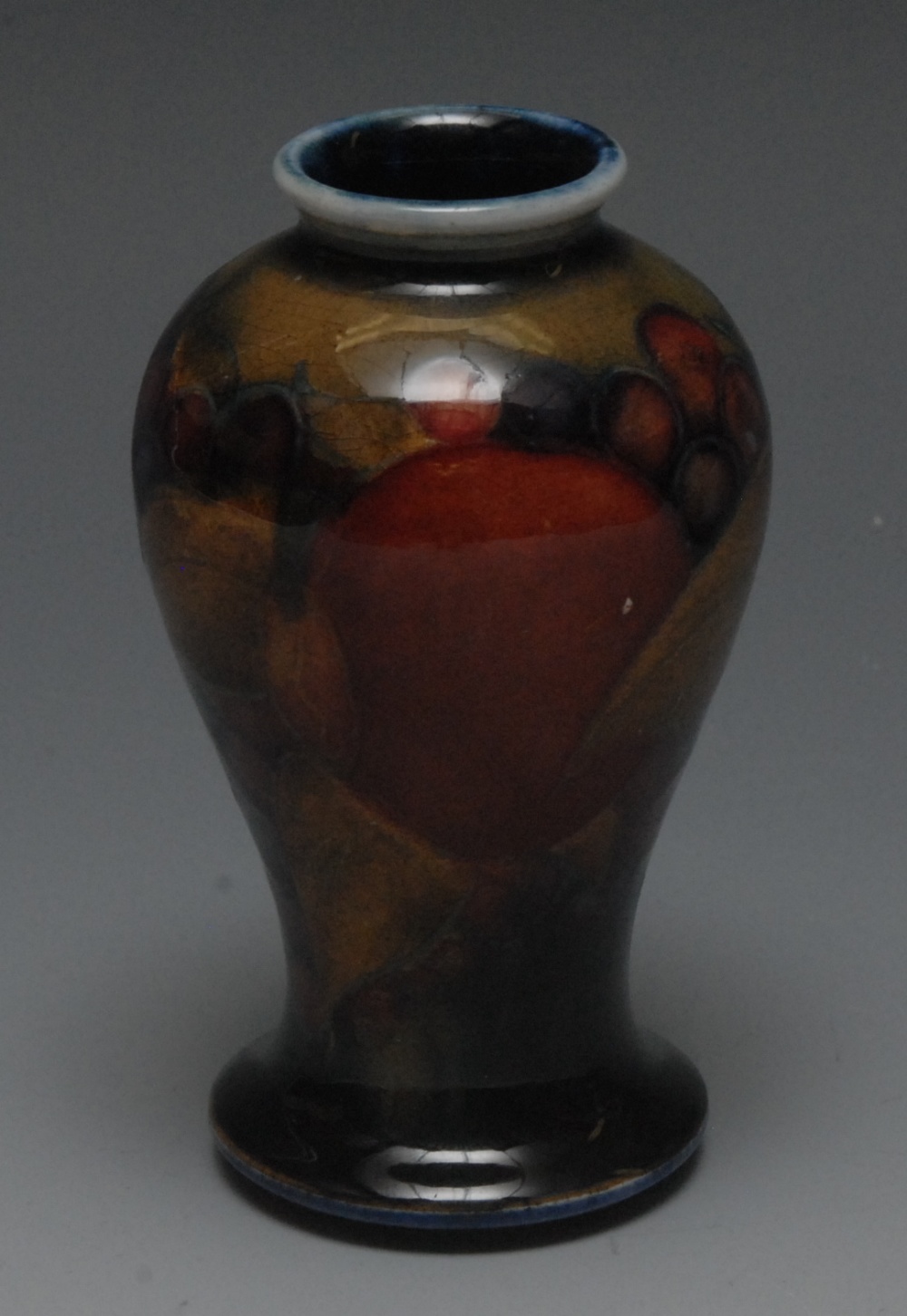 A Moorcroft Pomegranate pattern miniature  inverted baluster vase, tube lined with large fruit and