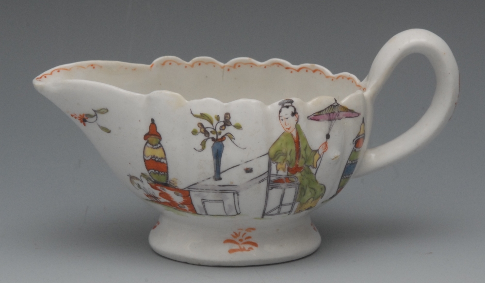 A Derby lobed sauce boat, painted in polychrome with chinoiserie scene, with a Chinese figure seated