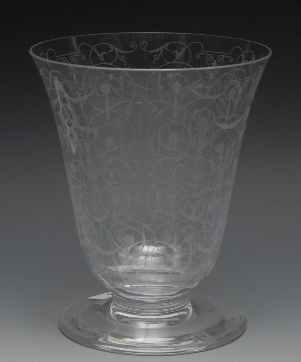 A Baccarat flared cylindrical vase, engraved with stylised urns and scrolling foliage, circular