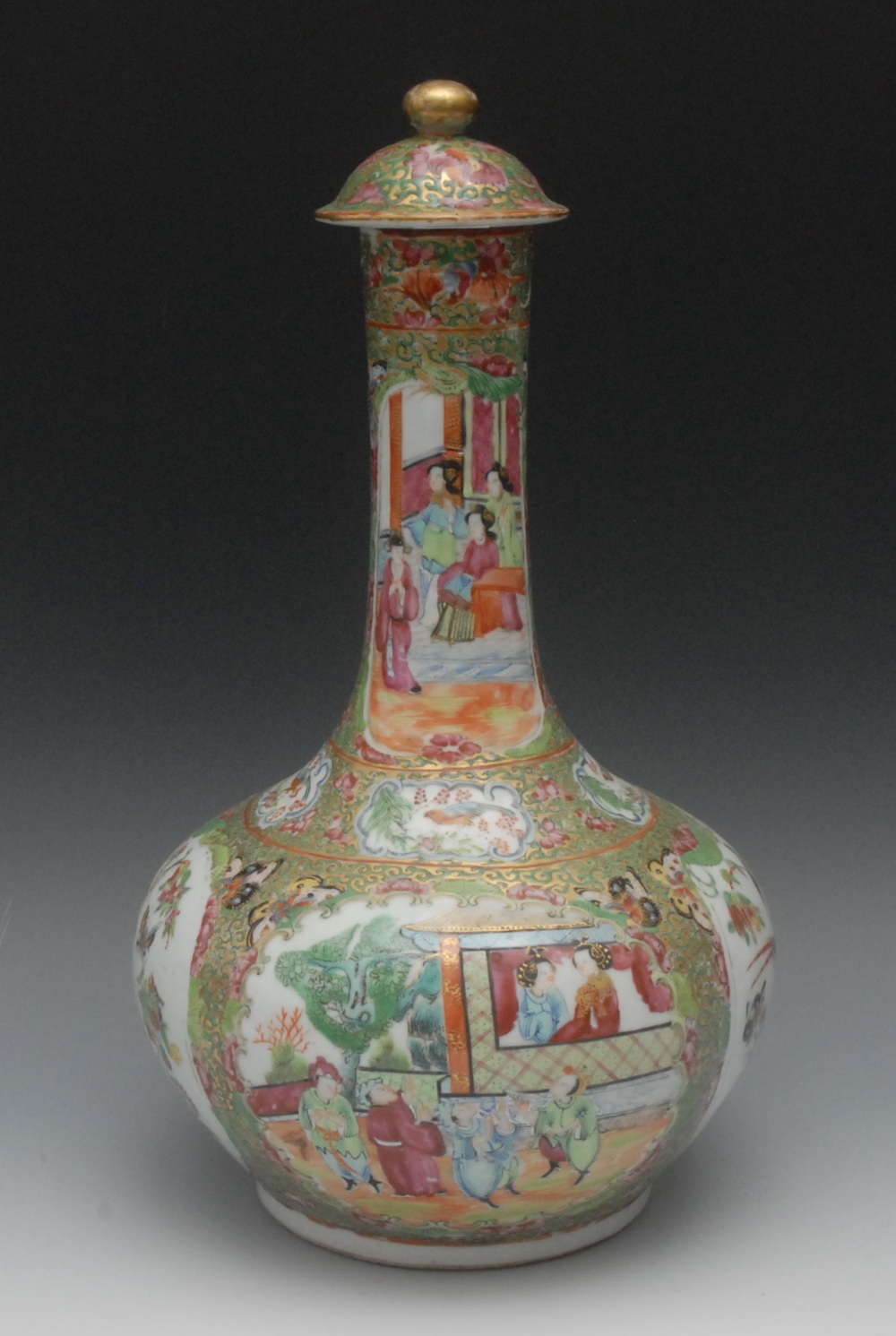 A Chinese Famille Verte bottle vase and cover, typically decorated with figures  and attendants,