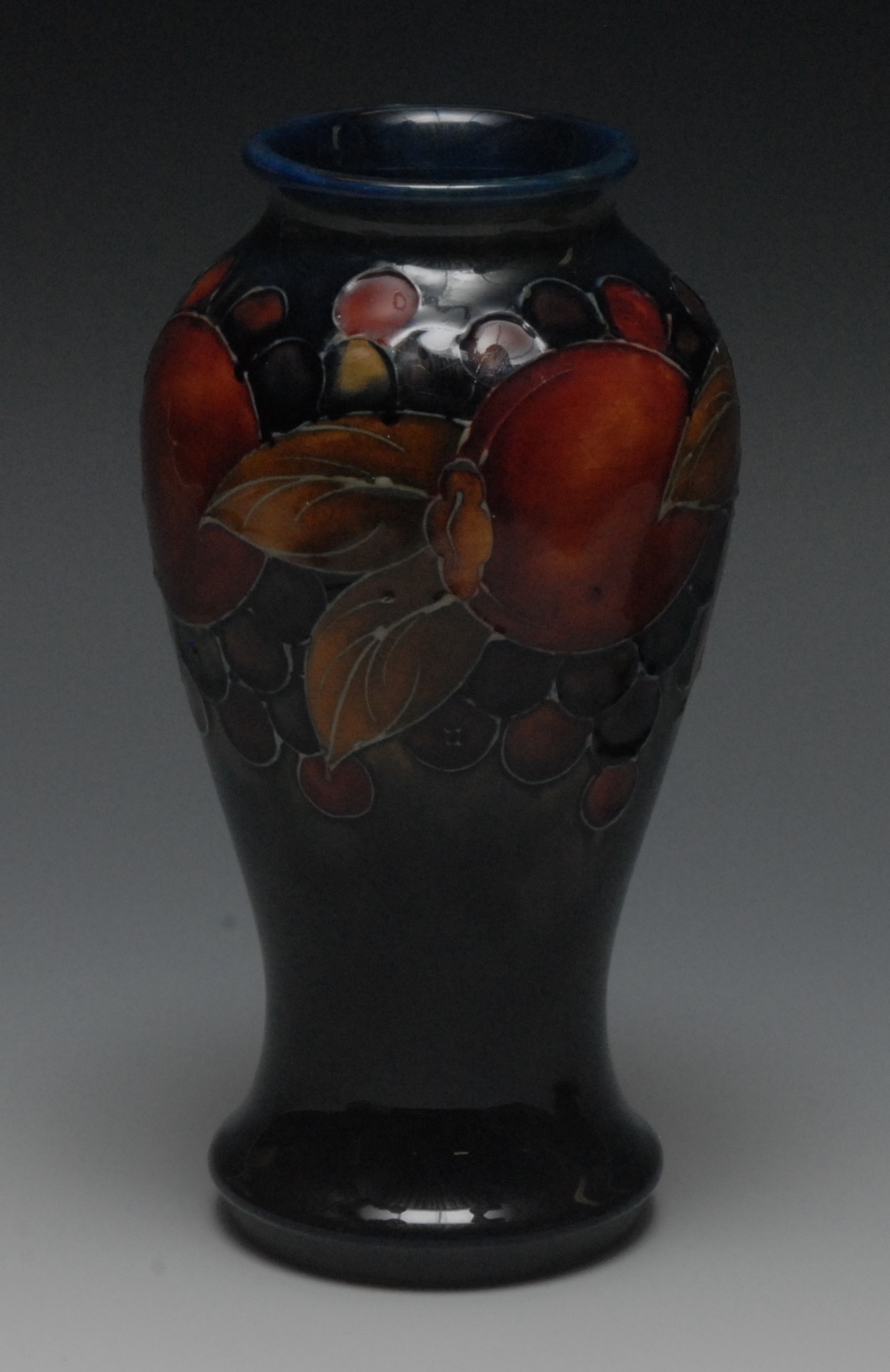 A Moorcroft Pomegranate pattern baluster vase, tube lined with fruit and berries, on a mottled