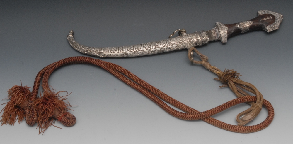 An Arabian jambiya/ khanjar, white metal mounted wooden hilt, curved blade and scabbard, 42cm long