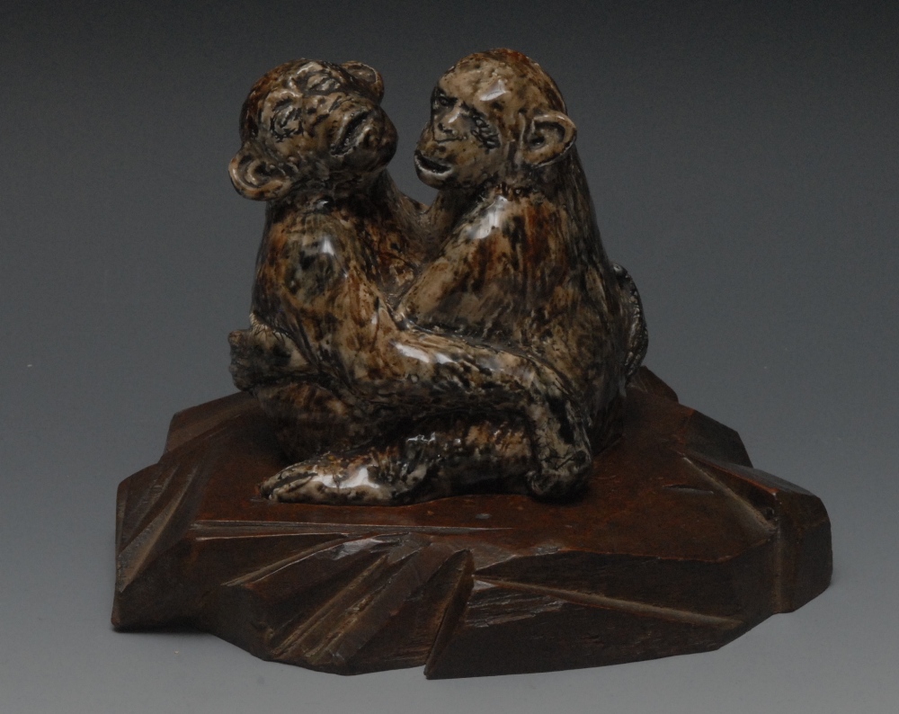 A Barry Pittar model, of two chimpanzees embracing, in mottled tones of brown, 10cm high, signed