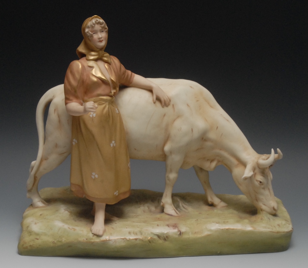 A Royal Dux  figure group, of a milkmaid, standing barefooted, by a horned cow, 32cm high, pink