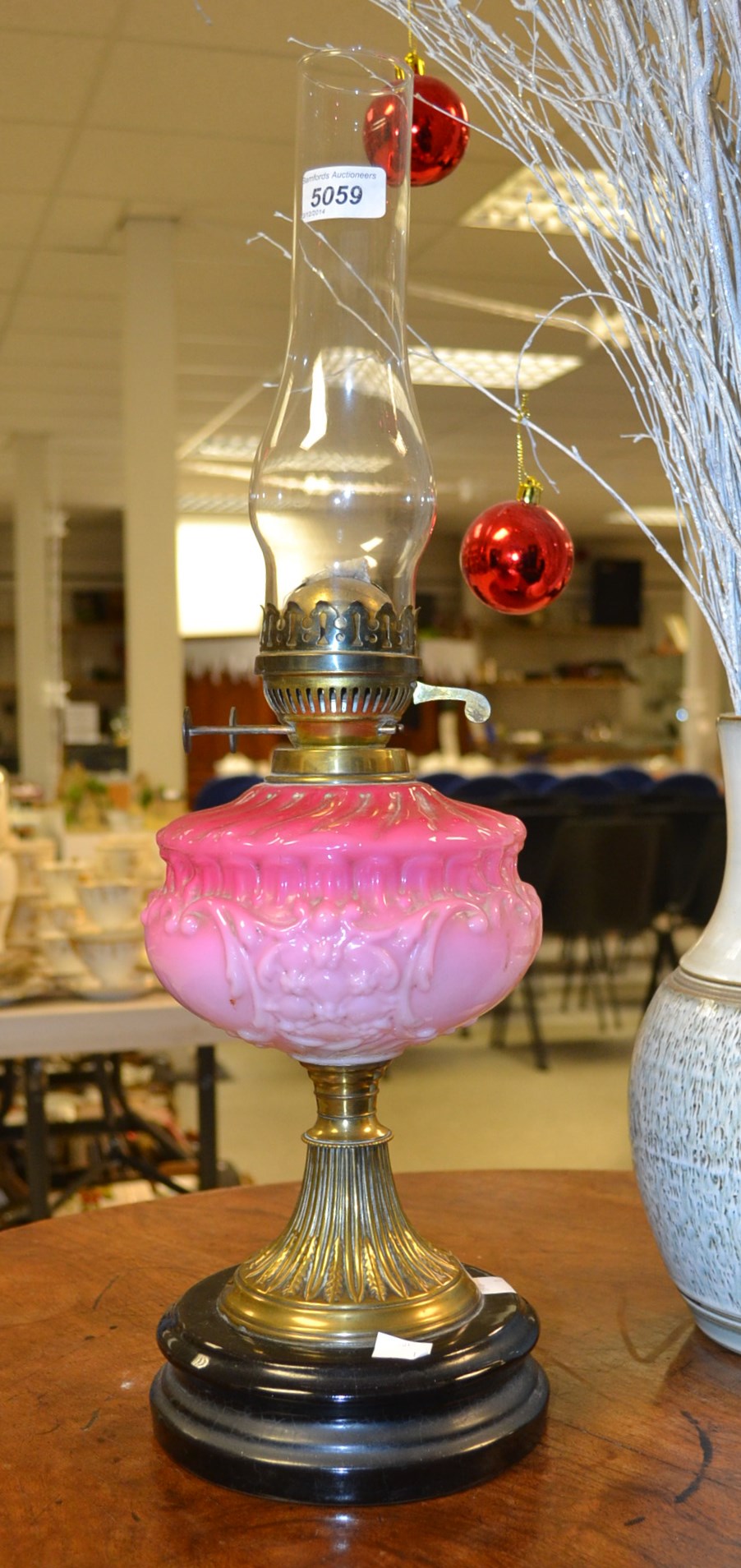 A pink opaque glass Victorian oil lamp