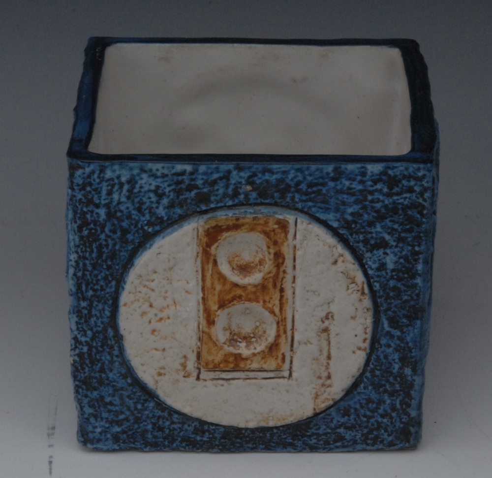 A Troika square vase,  designed by Louise Jinks, incised and in relief with roundels, in tones of