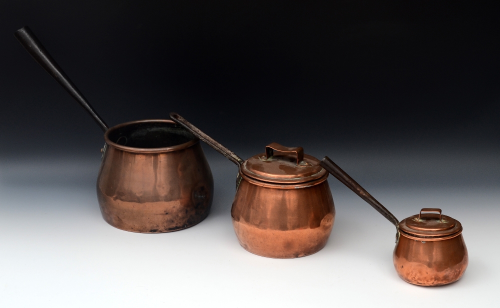A George III copper bowed saucepan, steel tubular handle, 17cm diam, c.1780; others, smaller (3)