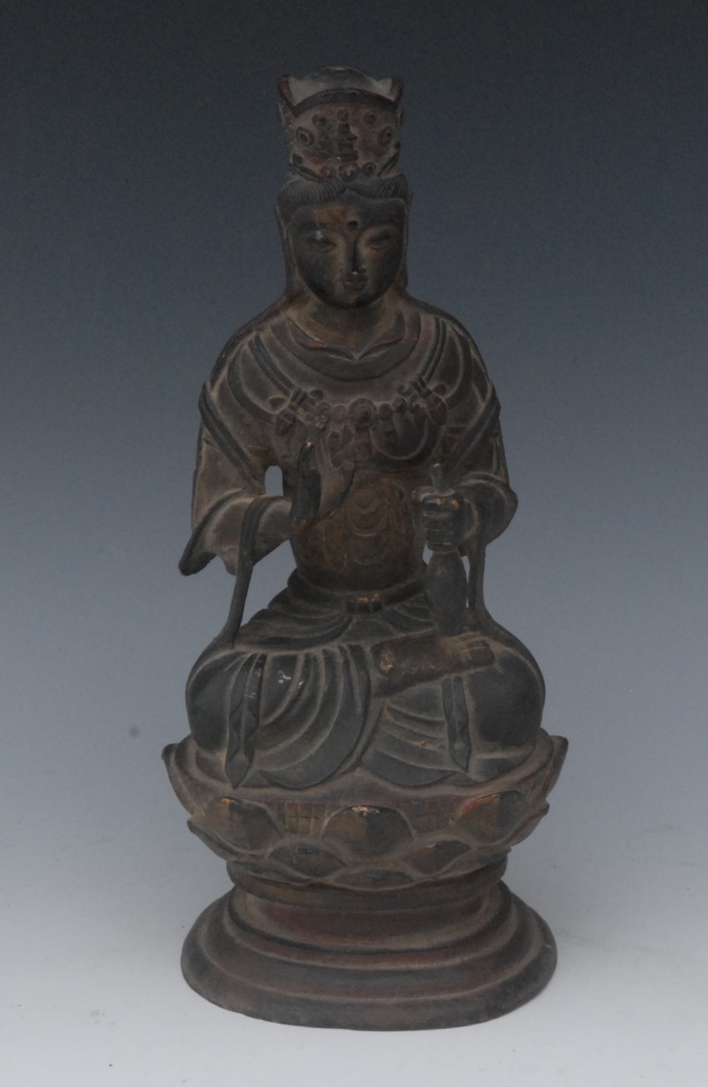 A Chinese bronze figure of a Bodhisattva,  seated on a lotus throne, 25cm high