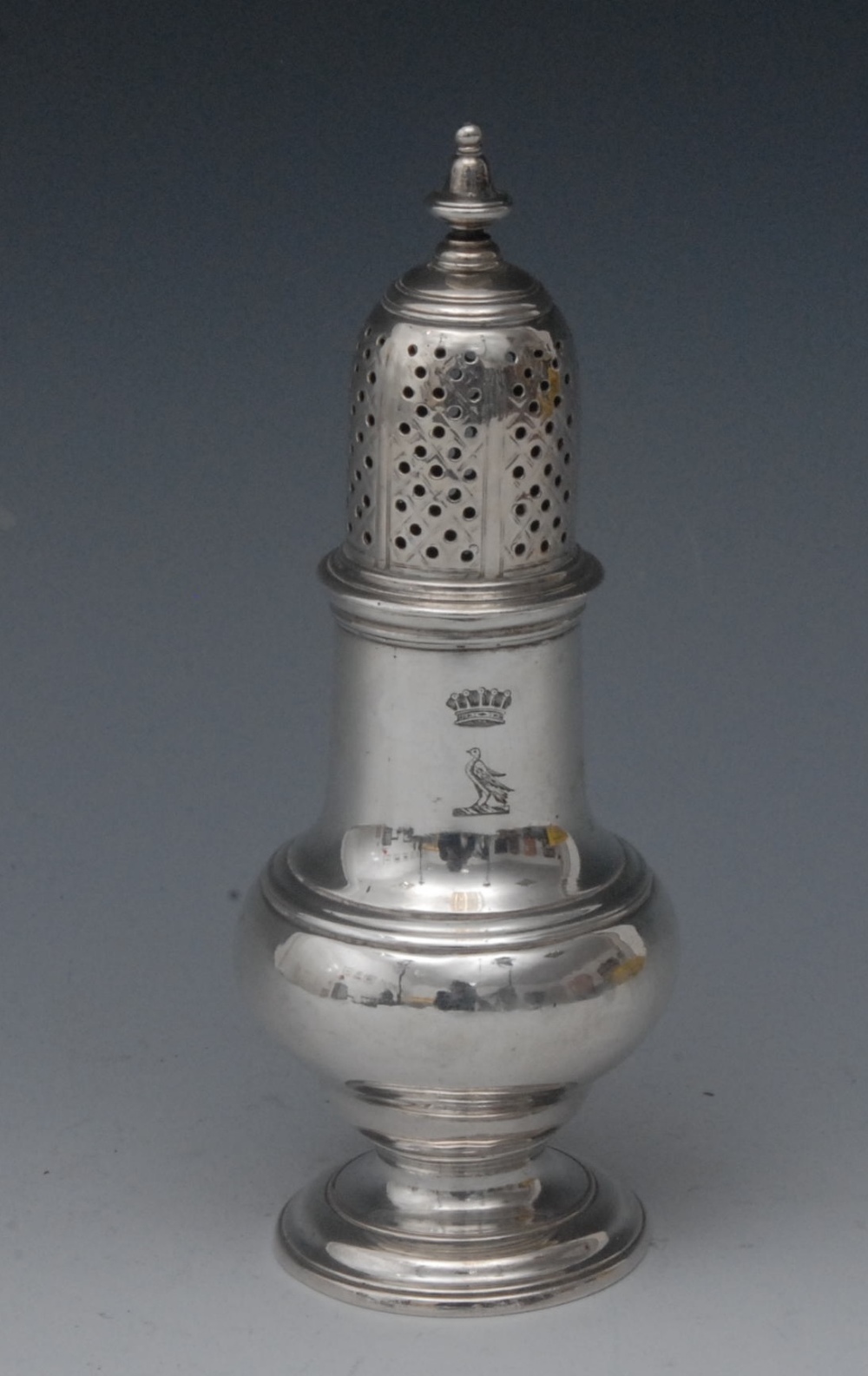 A George II silver pear shaped castor, knop finial,  pierced bell shaped cover, moulded circular