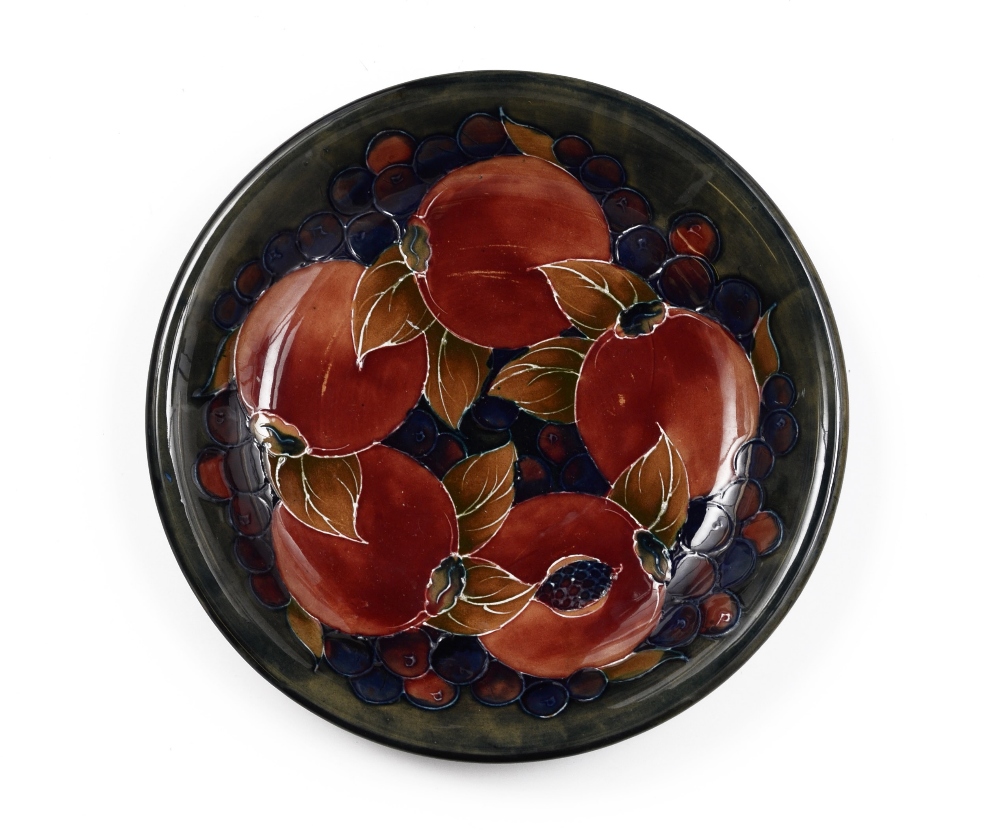 A Moorcroft Pomegranate pattern circular plate, tube lined with large fruit and berries, in