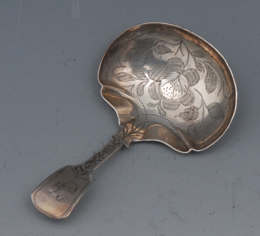 A George IV silver Fiddle pattern caddy spoon, the oval bowl with fluted angles, bright-cut engraved