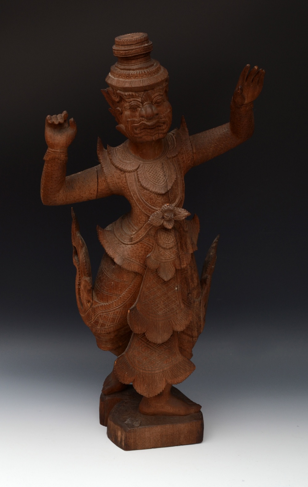 A large Asian hardwood carving, of a dancing figure, in ritual dress, 64cm high, probably