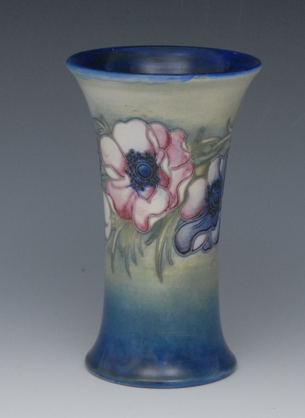 A Moorcroft Anemone pattern flared cylindrical salt glazed vase, tubelined with blue and pale pink