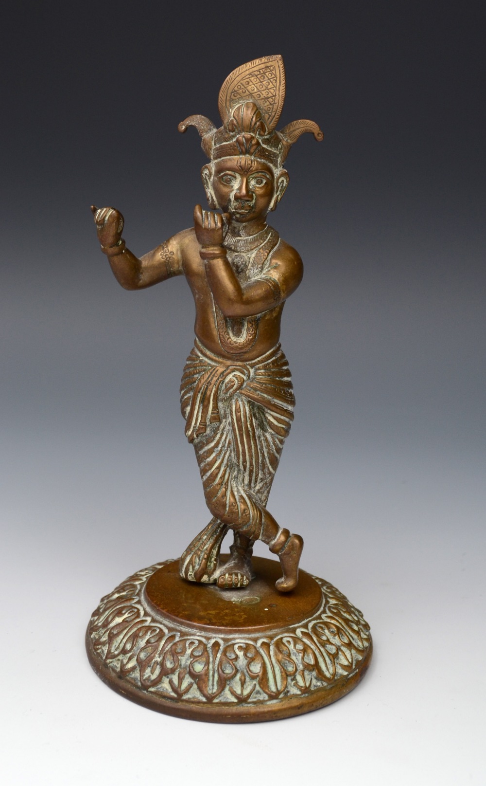 Burmese School, a bronze, of a flautist, circular lotus base, 19cm high