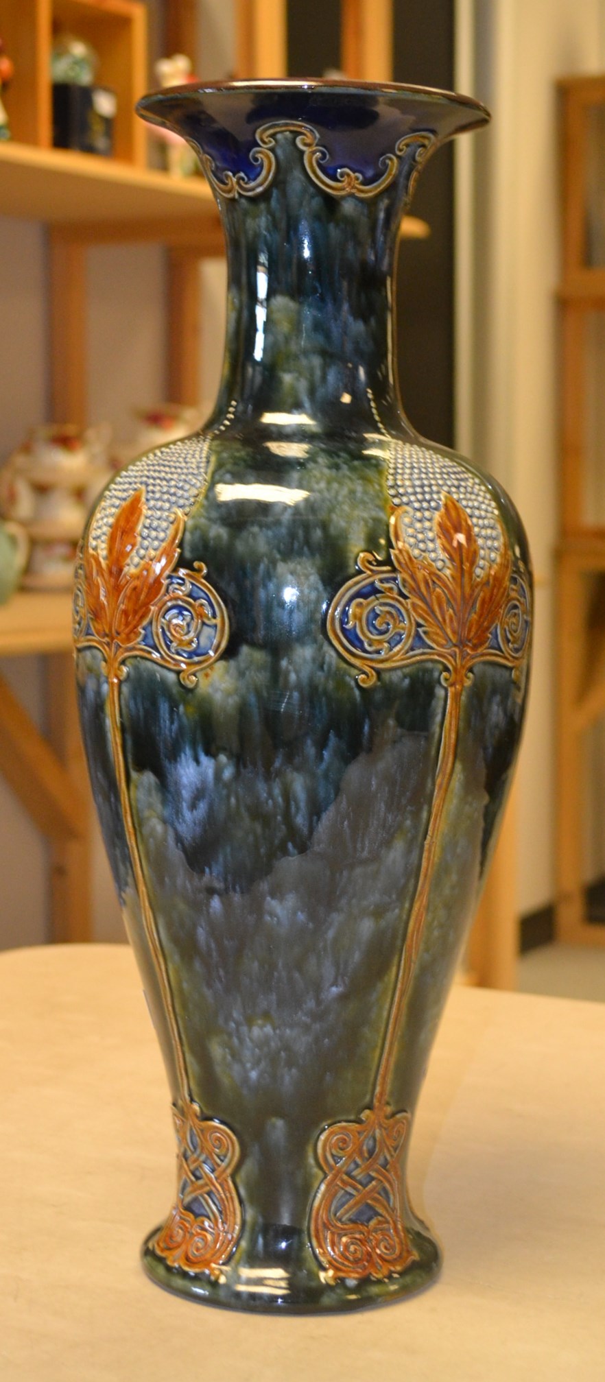 A large Royal Doulton Art Nouveau pottery vase, relief decorated with stylized floral and Celtic