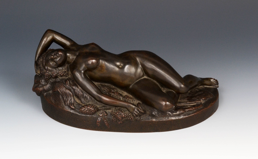 Continental School (19th Century), a dark patinated bronze,of a nude Bacchic nymph, reclining on a