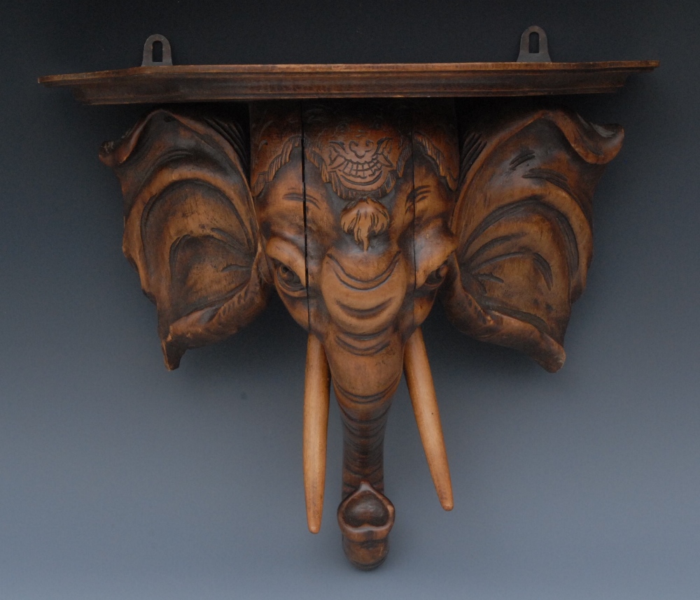 A 19th century Continental softwood wall bracket, probably Italian, well carved as the head of an