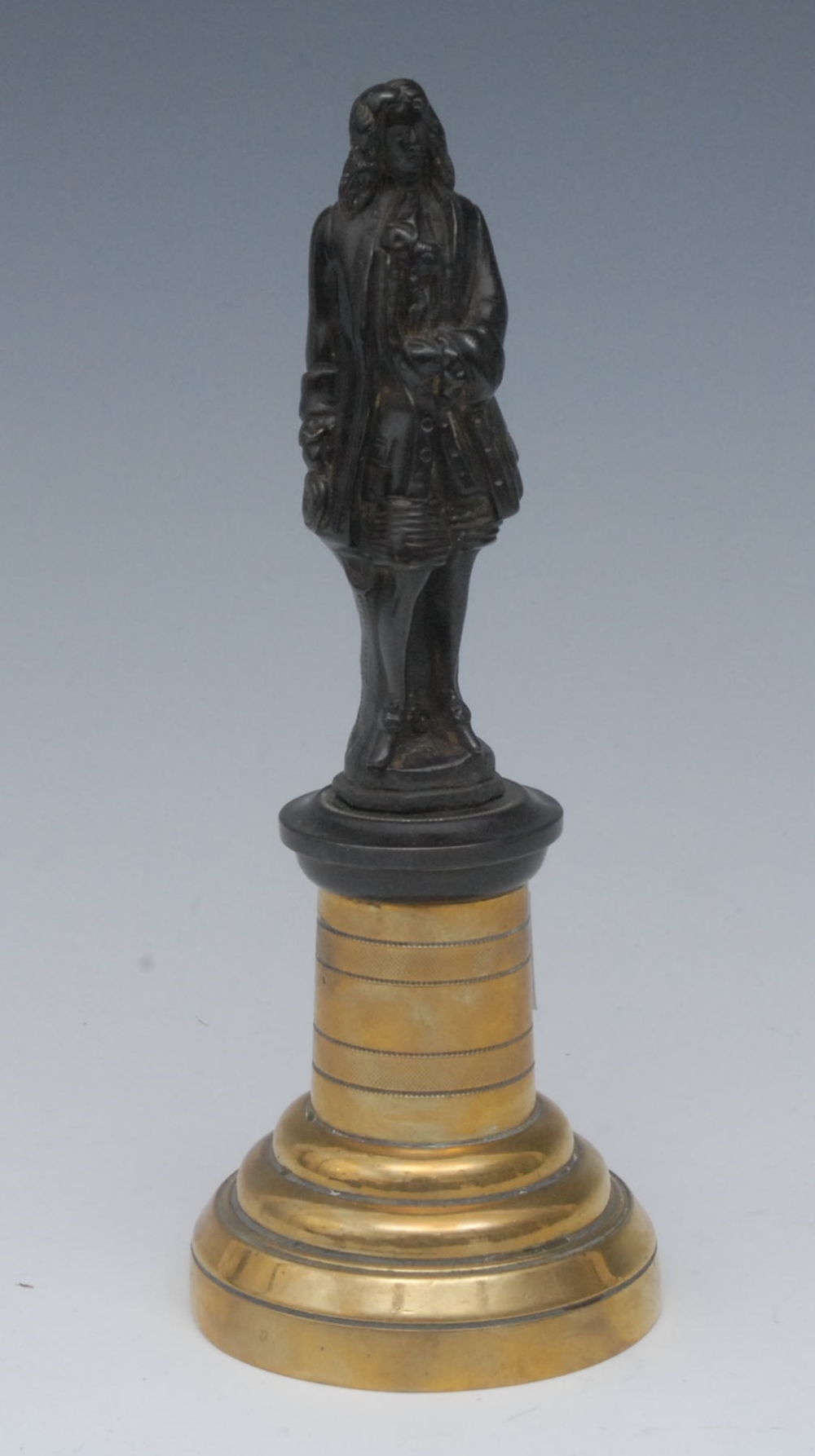 A 19th century dark patinated bronze desk model, of a gentleman in 17th century dress, polished