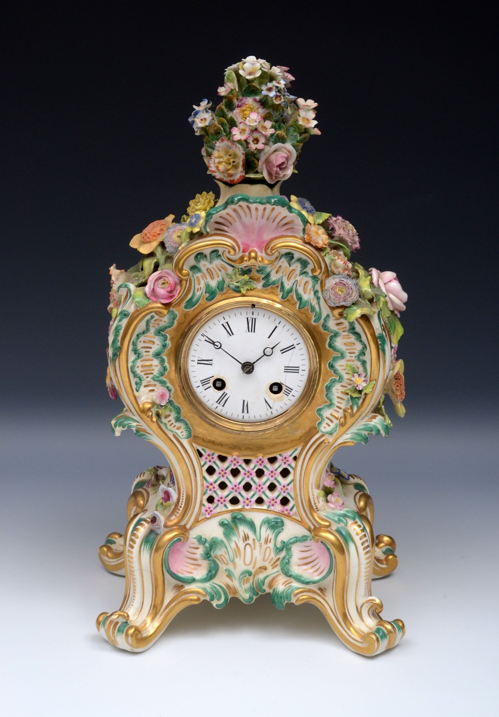 A Coalbrookdale type porcelain cartouche shaped mantel clock, 8cm enamel dial inscribed with Roman