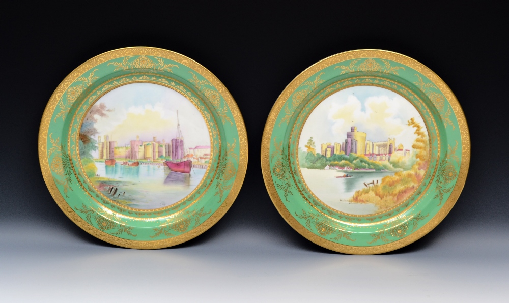 A pair of Minton circular wall plates, painted by J.Woby, signed, Windsor Castle and Caernarvon