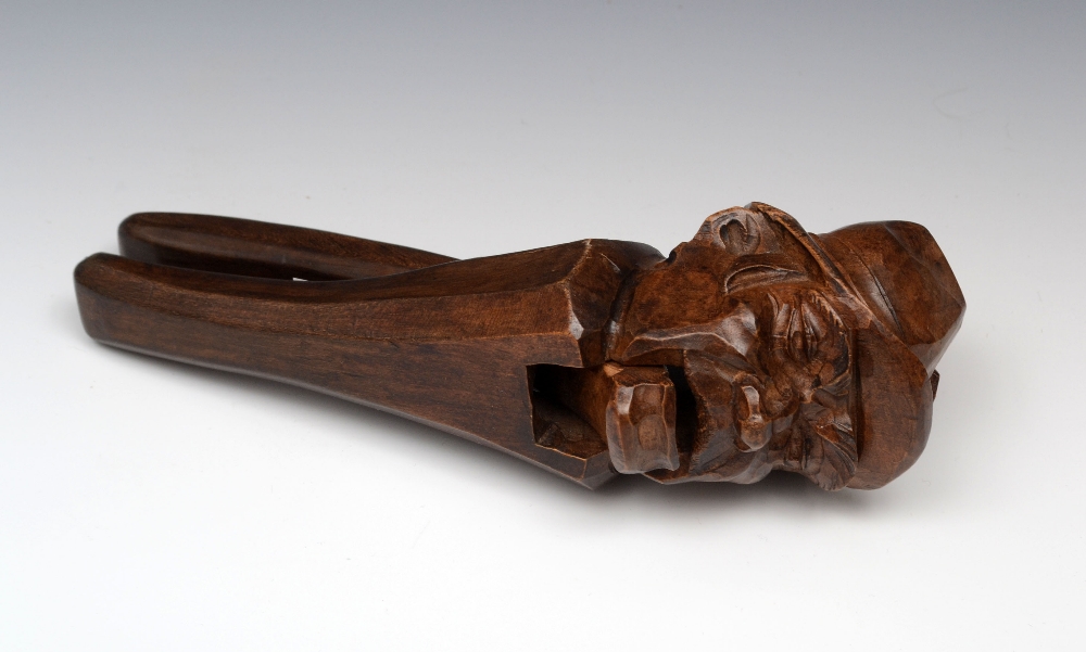 A large Black Forest novelty lever nut cracker, carved as the head of a Tyrolean gentleman wearing