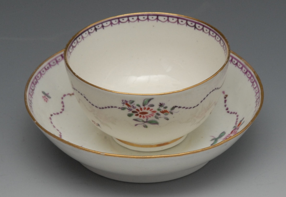 A Caughley Dartboard pattern tea bowl and saucer, the centre with divided roundel in colours,