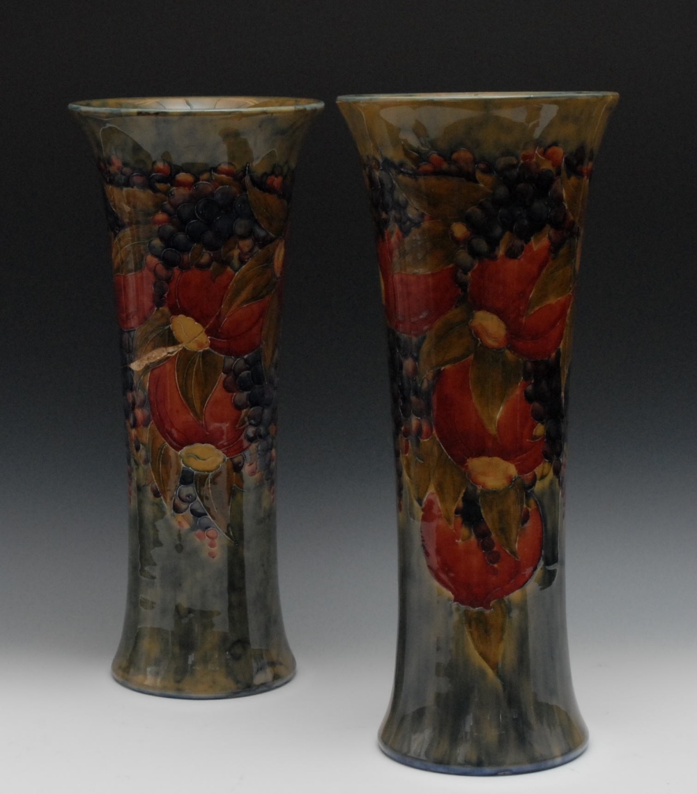 A pair of large Moorcroft Celadon Pomegranate pattern flared cylindrical vases, tube lined with