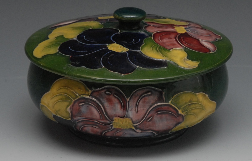 A Moorcroft Hibiscus pattern powder jar and cover, tube lined with large flowers and foliage, on a