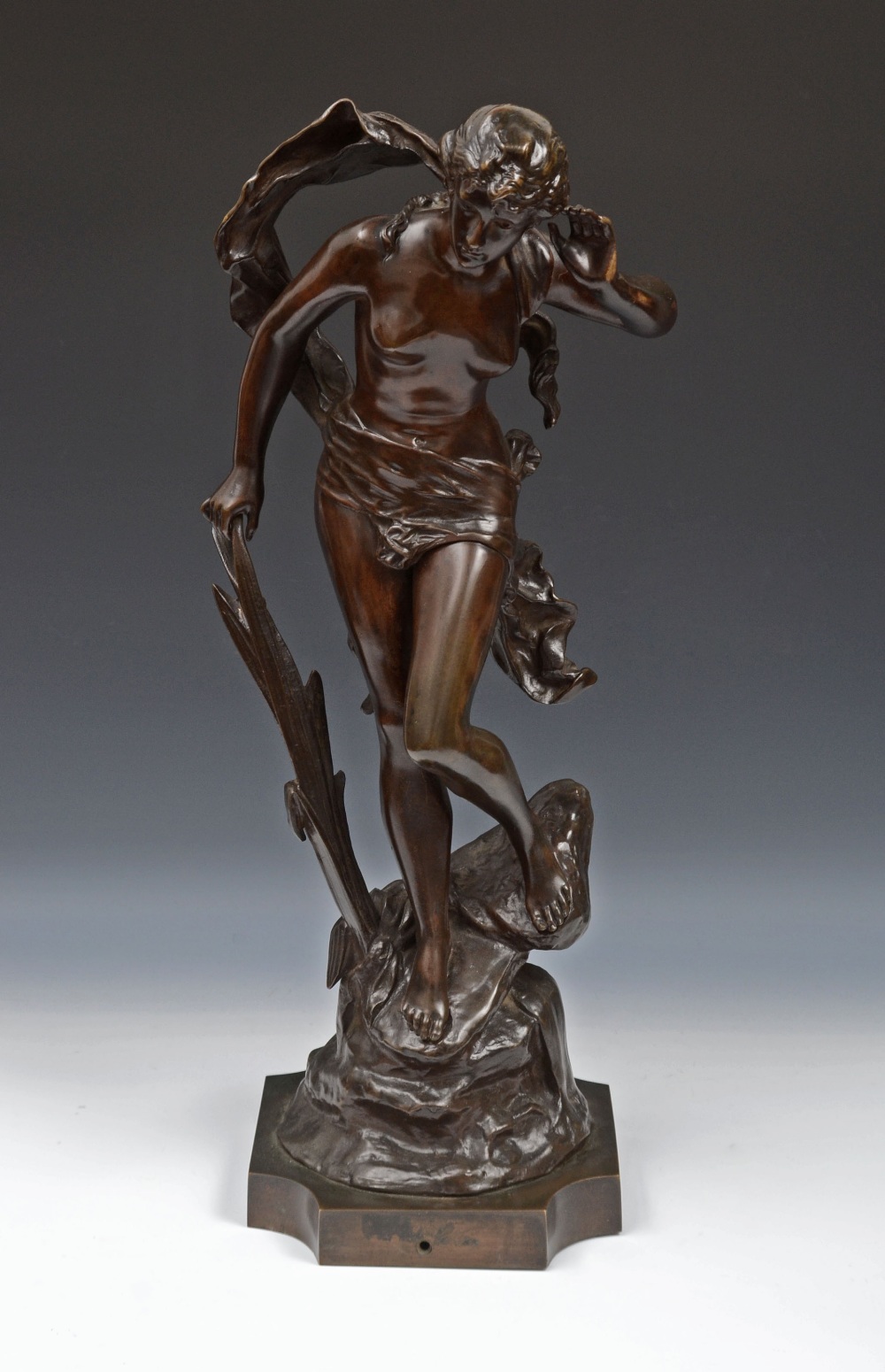 Edouard Drouot (1859 - 1945), a brown patinated bronze, of a scantily glad nymph, listening