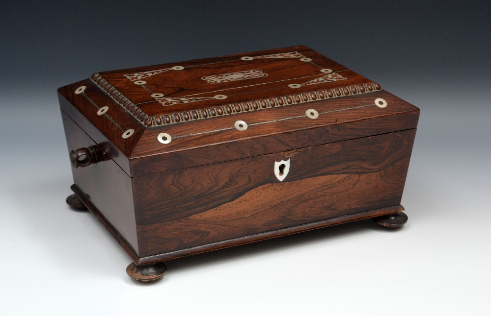 A George IV rosewood sarcophagus work box, hinged cover inlaid in mother of pearl with leafy stems,