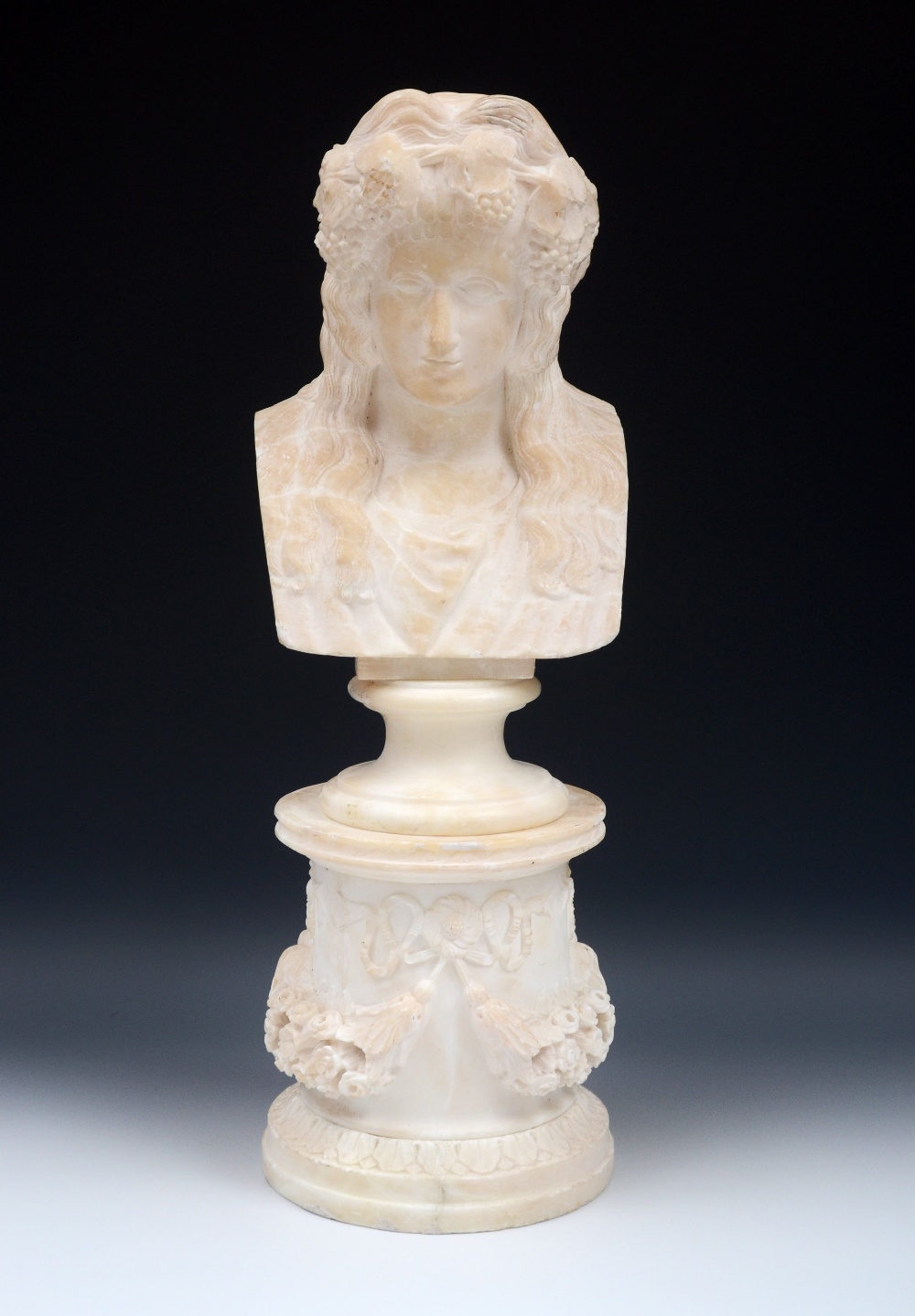 French School (19th century), an alabaster portrait bust, of a Bacchic maiden, waisted socle,